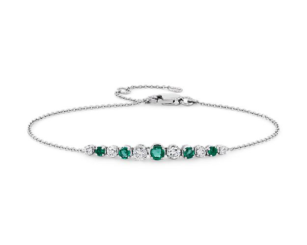 Shine day and night with these brilliant graduated prong-set emeralds and diamonds set against 14k white gold, on a delicate cable chain. For added versatility, bracelet can be adjusted in length.
