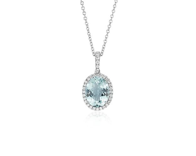 Elegant in every way, this aquamarine and diamond pendant features a single aquamarine framed by thirty-three pavé-set round diamonds in 14k white gold with a matching cable chain necklace.