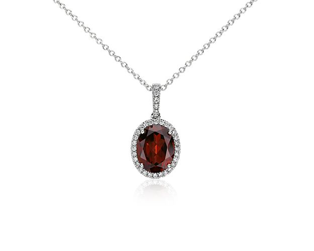 Elegant in every way, this garnet and diamond pendant features a single garnet framed by thirty-three pavé-set round diamonds set in 14k white gold with a matching cable chain necklace.