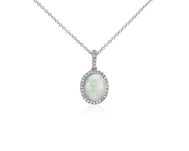 Elegant in every way, this opal and diamond pendant features a single opal framed by thirty-three pavé-set round diamonds in 14k white gold with a matching cable chain necklace.
