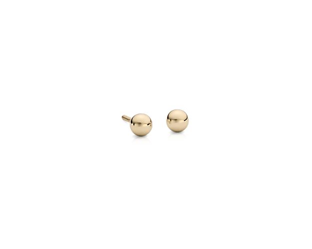 Simply classic, these children's ball stud earrings are crafted from hollow 14k gold in a petite design with a secure screw backing closure.