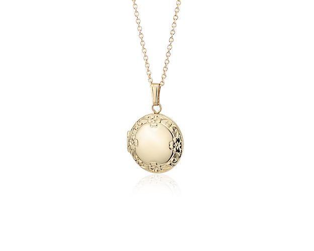 An heirloom keepsake, this petite hollow locket is delicately crafted from 14k gold with an intricate floral design and opens to hold two tiny pictures. Engrave for a personalized touch.