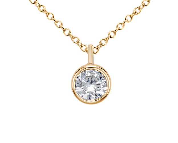 A key piece you'll wear every day, this bezel solitaire pendant setting in polished 14k yellow gold can be set with your choice of round diamond.  It comes suspended from a matching adjustable cable chain 16-18inches in length.