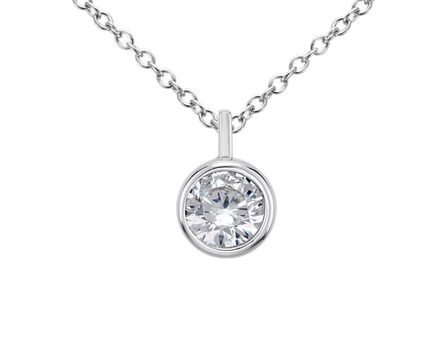 A key piece you'll wear every day, this bezel solitaire pendant setting in polished platinum can be set with your choice of round diamond. It comes suspended from a matching adjustable cable chain 16-18inches in length.
