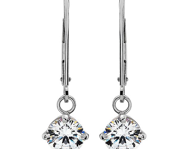 Put a twist on a classic with these dangling four-prong diamond earrings. Crafted in polished 14k white gold to complement your choice of round diamonds, they are finished with a secure lever back that completes their slim silhouette and go from dressy to everyday wear with ease.*Lever back length @ 18mm