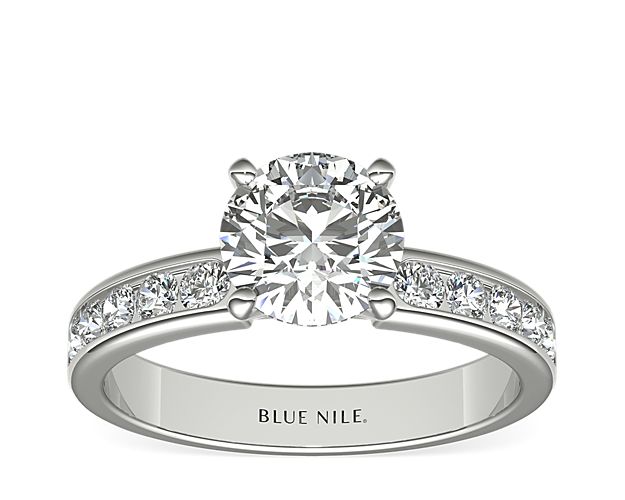 Distinctly beautiful, this diamond engagement ring showcases ten round diamonds that are set in a platinum channel design to accent your center diamond.