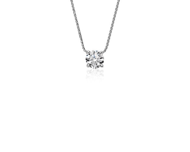 Classic elegance, this beautiful platinum pendant showcases a 0.60 carat brilliant Blue Nile Signature Ideal Cut round diamond set in a contemporary floating bail design with a luxurious adjustable length chain. Versatile style to celebrate everyday or the most special of occasions. This pendant is accompanied by a GCAL report.