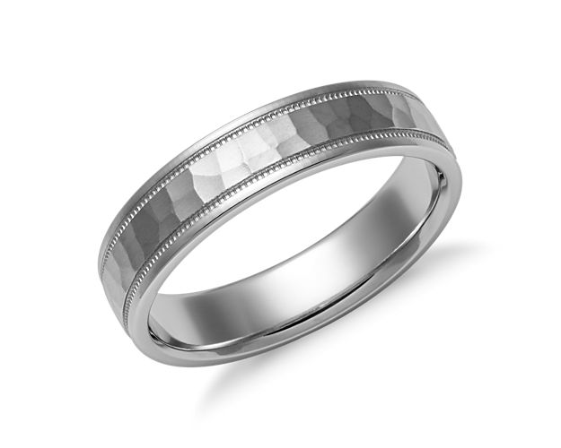 This 14k white gold wedding ring is meticulously crafted with an artistic hammered finish, inset milgrain borders, and brightly polished edges. Softly rounded inner edges allow for comfortable regular wear.