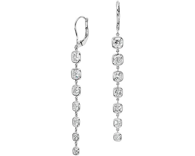 Dramatic and sophisticated, these stunning diamond drop earrings showcase cascading brilliance with fourteen, ideally matched, cushion-cut diamonds bezel-set in classic 18k white gold.