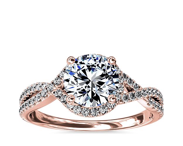 Capture your lasting love with this stunning 14k rose gold engagement ring that showcases an elegant drape of pavé-set diamonds around your center stone and along the twisting shank for a captivating look.
