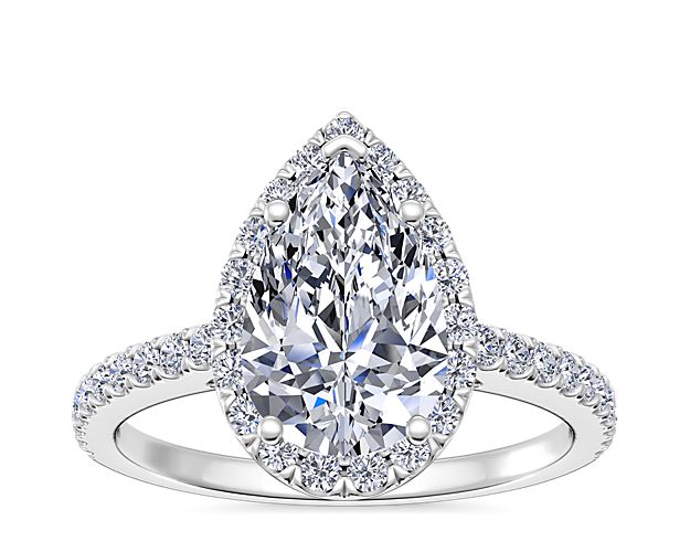 This classic platinum pear-shaped halo diamond engagement ring features a single row of micro-pavé set round brilliant-cut diamonds and is crafted to perfectly frame the pear-cut center diamond of your choice.