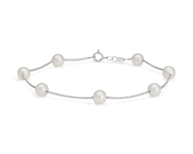 Break out of the classic pearl strand mold with this "Tin Cup" pearl bracelet, a style made famous by Rene Russo in the feature film of the same name. Six white Freshwater cultured pearls are stationed along a classic 14k white gold cable chain. This delicate twist is a great first pearl purchase or beautiful bridesmaid gift.
