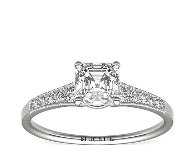 Ideal for any center diamond of your choice, this platinum engagement ring showcases a diamond accent along the shank and milgrain detailing.