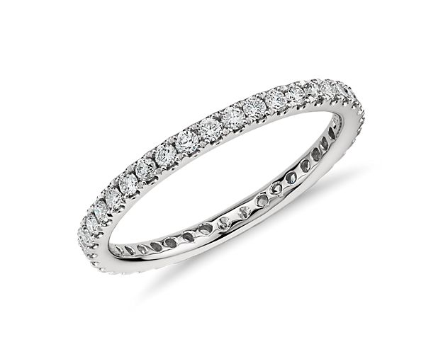 Elegant and sparkling, this petite diamond ring features round pavé-set diamonds around the entire design of the platinum eternity ring.