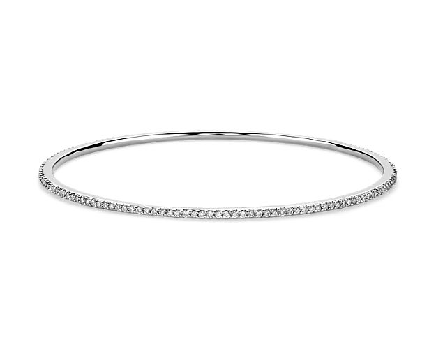 This delicate eternity bangle bracelet showcases round diamonds pavé-set in 18k white gold, perfect for layering with others to achieve the beautiful and chic look. The diameter of this bangle is 2 2/5" x 2 2/5".