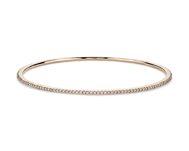 This delicate eternity bangle bracelet showcases round diamonds pavé-set in 18k yellow gold, perfect for layering with others to achieve the beautiful and chic look. The diameter of this bangle is 2 2/5" x 2 2/5".