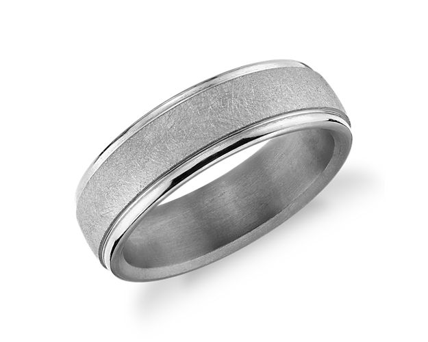 Tantalum construction provides durability and strength to this minimalist wedding band. A subtle swirling texture in the center of the band is surrounded by round, polished edges to provide a tasteful contrast.