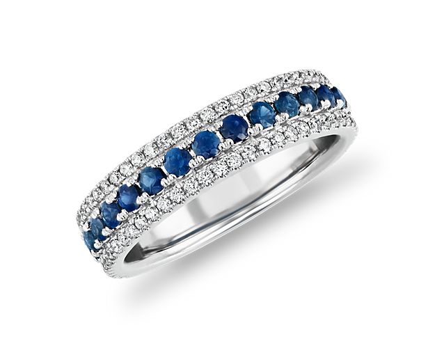 A trail of velvety-blue sapphires, set between two rows of brilliant pavé diamonds, makes this 14k white gold band a true classic.
