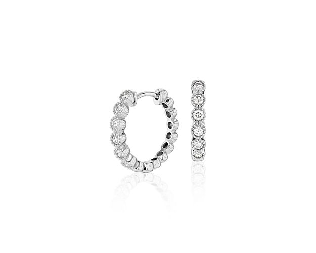 Our petite diamond milgrain hoop earrings are so versatile you'll reach for them every day. Round brilliant-cut diamonds are set in 14k white gold, with beautiful milgrain detailing on the bezel edges for a look that adds subtle sparkle to an essential style. Diameter of hoop measures 5/8 Inch.