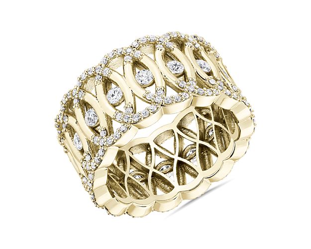 Brilliant pavé-set diamonds enliven the arch of each oval in this intricately latticed 14k yellow gold eternity ring. A dazzling round-cut diamond shines from the center of every interlocking loop for all over sparkle.