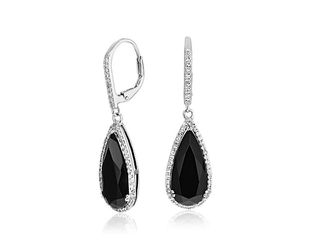 Elegant pear-cut black onyx grace these sterling silver earrings, each enlivened by a twinkling halo of white topaz.