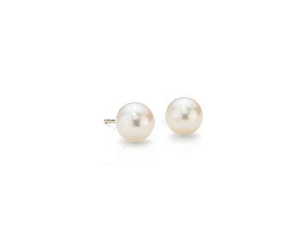 An essential style, these Freshwater cultured pearl stud earrings feature two luminous white pearls mounted on bright 14k yellow gold posts with push backs for pierced ears. These pearl stud earrings provide a classic look with incredibly versatility.