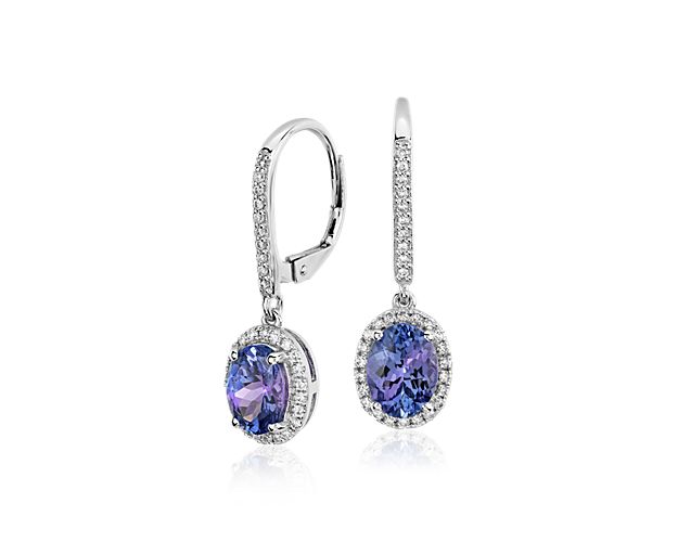 Delicate in design, these earrings showcase vibrant oval tanzanite gemstones surrounded by sparkling micropavé diamonds framed in 14k white gold.