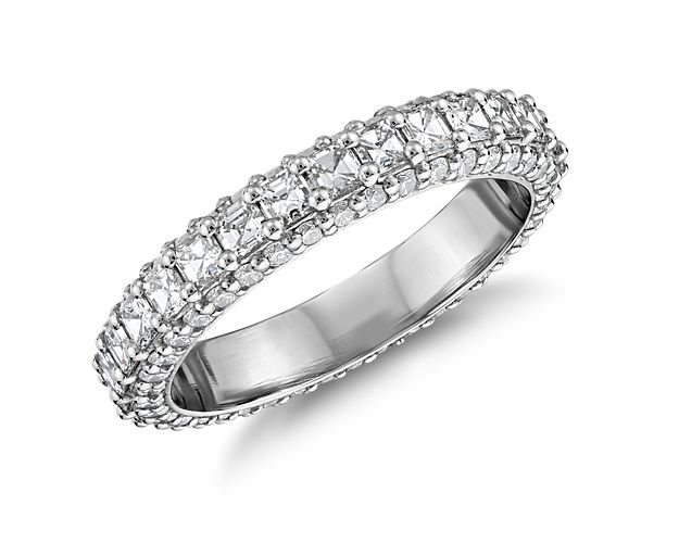 An exquisite platinum diamond eternity ring that is masterfully crafted, embellished with a triple-row band featuring Asscher-cut diamonds