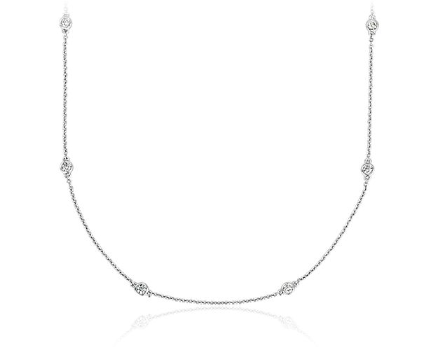 Twelve petite diamonds are bezel-set in 14k white gold, and stationed along a cable chain necklace. The delicate heart accent can be pulled to adjust the length of the necklace.