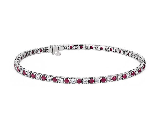 Luxuriant and colorful, this Riviera bracelet features alternating deep red rubies and round brilliant-cut diamonds. 14k white gold prong settings lend security to the classic tennis bracelet style and a box clasp with hidden safety keeps this stunner secure.