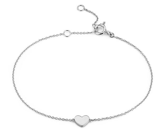 Fall head over heels for this petite heart bracelet. Crafted in bright 14k white gold, this sweet little polished heart is stationed along a delicate cable chain that can be adjusted in length for the perfect fit.