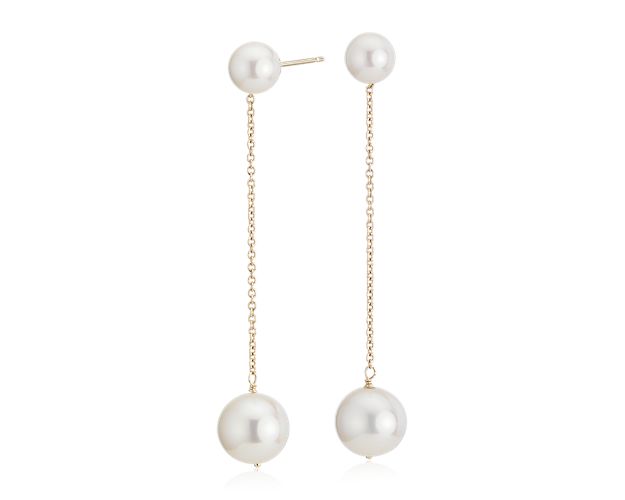 A fresh way to wear classic pearls. These line drop earrings feature white Freshwater cultured pearls on classic 14k yellow gold cable chains and dangle a little more than two inches from the ear.