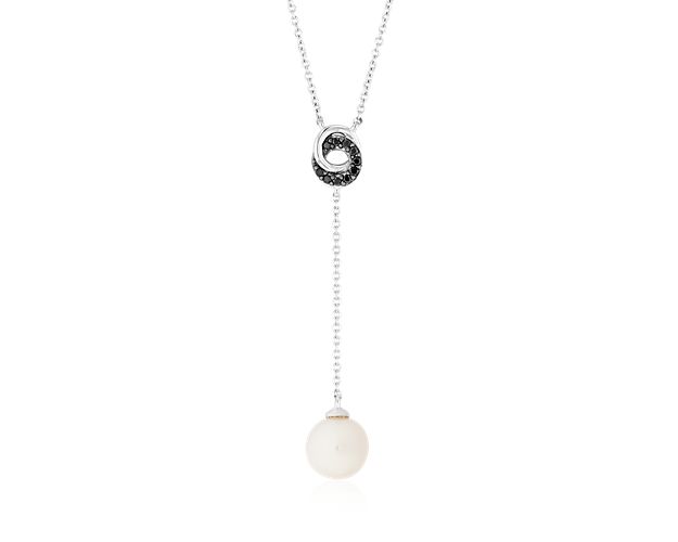 Classic elegance given modern presentation, this 14k white gold drop pendant showcases lustrous Freshwater pearls suspended from a ring of bold black diamonds.