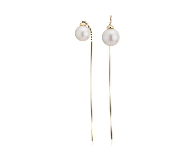 These graceful threader earrings showcase two freshwater cultured pearls and a thin bar drop in 14k yellow gold.