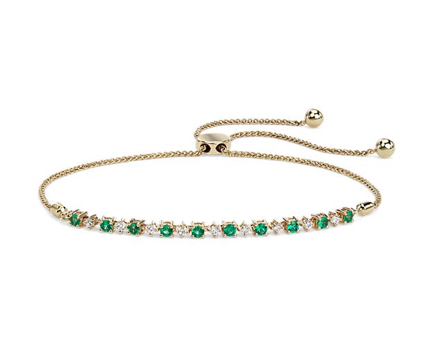 At once brilliant and vibrant, this petite 14k yellow gold bracelet draws its allure from a series of round-cut emeralds and diamonds. This wheat chain bracelet adjusts up to 10 inches and is secured with a bolo clasp.