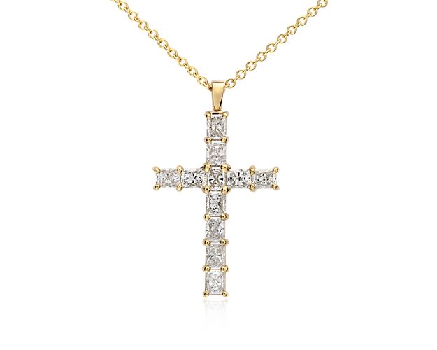 Meaningful and eye-catching, this diamond cross pendant features eleven brilliant radiant-cut diamonds set in polished 18k yellow gold. Suspended from a matching cable chain, this sparkling cross necklace makes an unforgettable gift.