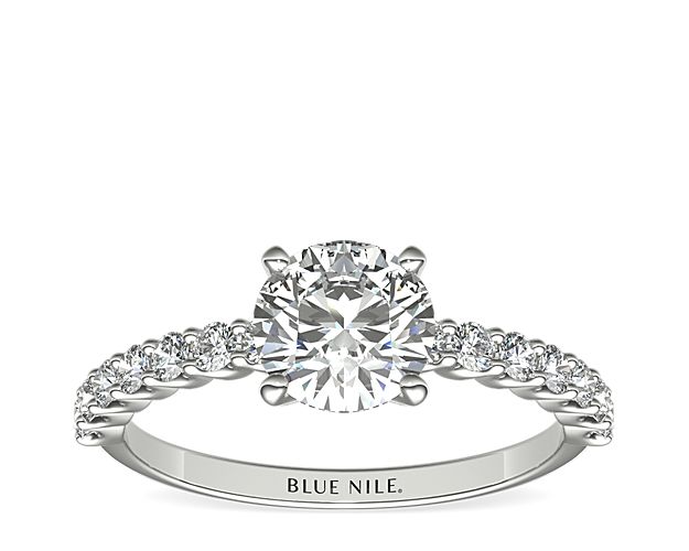 Exquisite in design, this diamond engagement ring features a delicate row of shared-prong set diamonds to beautifully frame your center diamond. Setting includes 1/3 carat total diamond weight.