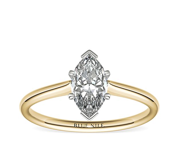Elegant in simplicity, this petite solitaire engagement ring is crafted in polished 18k yellow gold to create a classic frame for your center diamond.