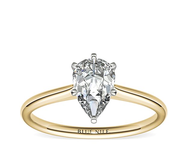 Elegant in simplicity, this petite solitaire engagement ring is crafted in polished 18k yellow gold to create a classic frame for your center diamond.