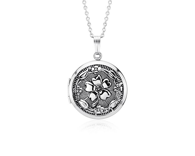 A touch of vintage style, this round locket is crafted from sterling silver and features a floral motif. The perfect keepsake, this locket is strung on a matching cable chain necklace.