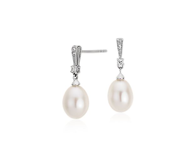 These classic Freshwater cultured pearl drop earrings go from wedding to work with ease. Demurely styled white drop pearls are accented with subtly glittering white topaz gemstones set in sterling silver. This beautiful pair of pearl earrings features a secure post closure and they make a versatile bridesmaid gift for your besties.