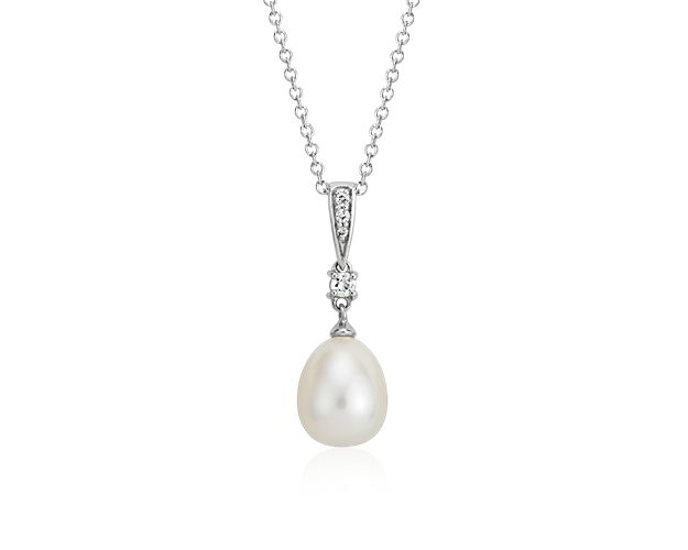 A mix of vintage style and modern simplicity, this Freshwater cultured pearl drop pendant features a lustrous white pearl accented by dainty white topaz gemstones. Set in a simple sterling silver frame with a matching cable chain, this pearl drop pendant also makes a beautiful bridesmaid gift.