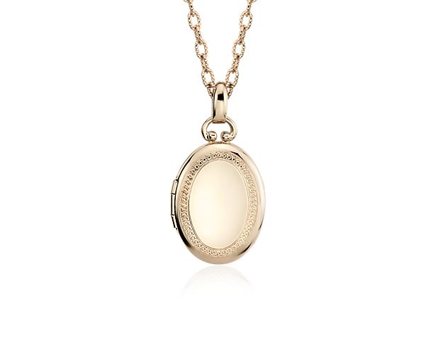 Carry loved ones close with this premium oval locket crafted in 14k yellow gold that opens with a snap clasp to present two photos. Suspended from a forzatina chain necklace, this substantial locket can be engraved on the front for a personalized gift.