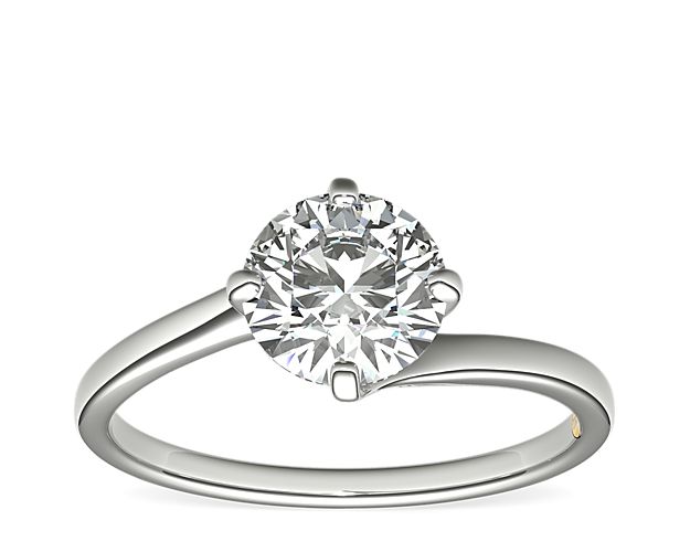 Sophisticated and elegant, this modern platinum engagement ring features a unique east-west bypass design to showcase  the center stone diamond of your choice. Zac infuses luxurious style by adorning each ring with a signature 18k yellow gold interior accent.