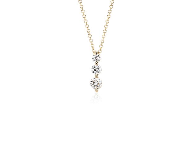 Symbolic of your past, present, and future, the three-stone diamond drop pendant showcases three round brilliant-cut diamonds in graduated sizes set in shared, 18k yellow gold prong settings for maximum brilliance. The pendant hangs from a delicate 18-inch classic cable chain with a secure lobster claw clasp.