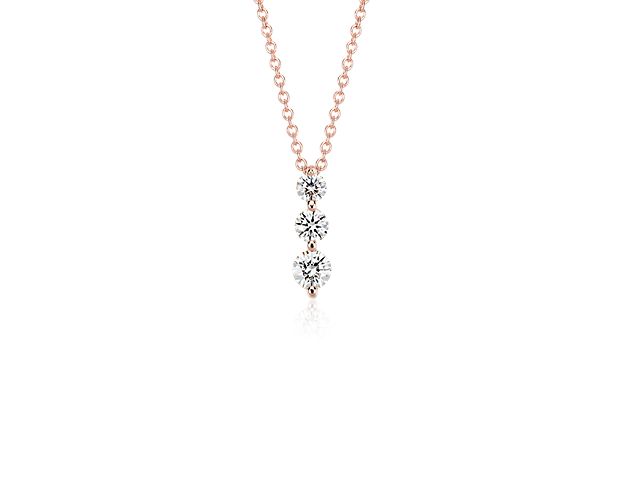 Symbolic of your past, present, and future, the three-stone diamond drop pendant showcases three round brilliant-cut diamonds in graduated sizes set in shared 18k rose gold prong settings for maximum brilliance. The pendant hangs from a delicate 18-inch classic cable chain with a secure lobster claw clasp.
