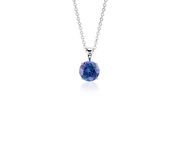 Vibrant and colorful, this gemstone pendant features a lush purplish-blue tanzanite set in a 14k white gold four-prong setting suspended from a dainty 18-inch cable chain. A classic piece of everyday luxury.