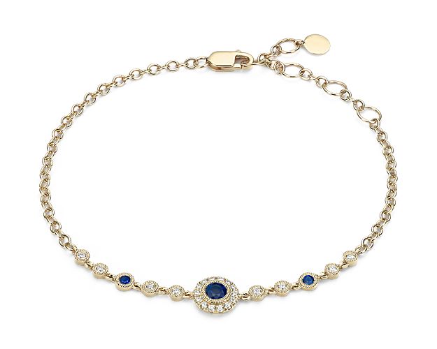 Inspired by vintage jewelry, this sophisticated 14k yellow gold bracelet features a milgrain halo with pavé-set diamonds that frame a beautiful round-cut sapphire that is flanked by additional diamond and sapphire stations. This piece will be treasured for years to come.