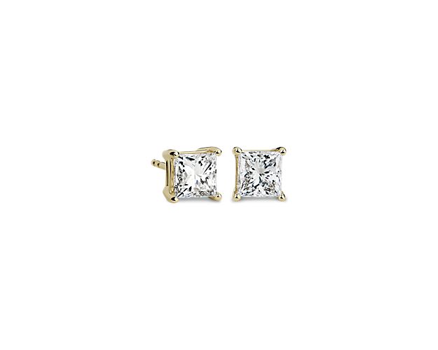 Beautifully matched, these diamond stud earrings feature a pair of princess, near-colorless diamonds set in 14k yellow gold four-prong settings with double-notched friction backs.