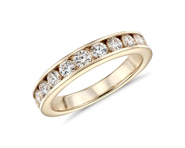 Both practical and pretty, a stunning row of round brilliant-cut diamonds is channel-set in polished 14k gold for a look that exemplifies classic design.